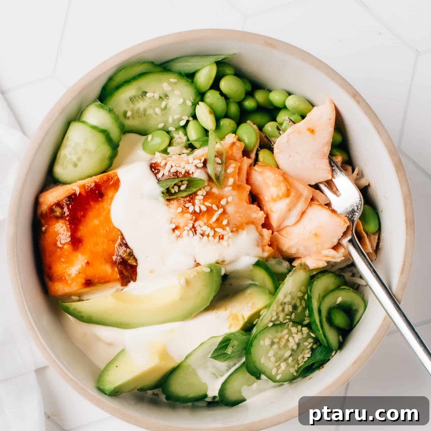Silken Asian Dressing 5 A delicious Honey Teriyaki Salmon Bowl, beautifully garnished with fresh green vegetables and a generous drizzle of creamy Asian dressing, ready to be enjoyed.