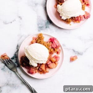 Easy Rhubarb Crisp on plates with ice cream.