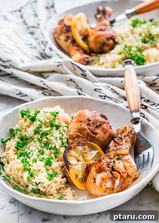 41 Succulent Chicken Drumstick Recipes You Can Make Effortlessly 12 Lemon Garlic Roasted Chicken Legs served on a plate with fluffy white rice.