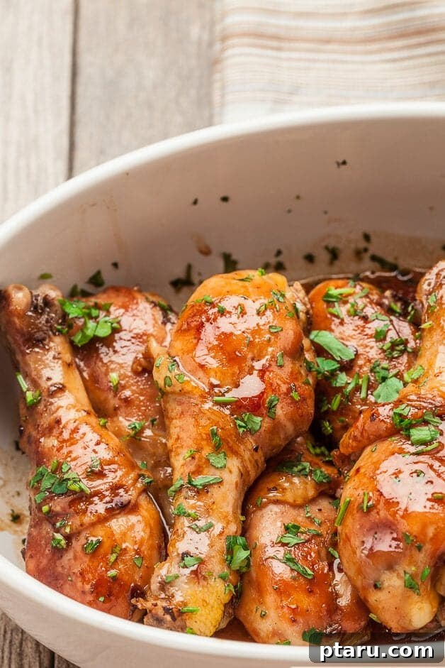 41 Succulent Chicken Drumstick Recipes You Can Make Effortlessly 13 Glossy Honey Soy Chicken Drumsticks beautifully stacked on a serving dish.
