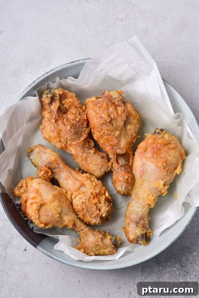 41 Succulent Chicken Drumstick Recipes You Can Make Effortlessly 21 Crispy Deep Fried Chicken Drumsticks artfully placed on a plate.