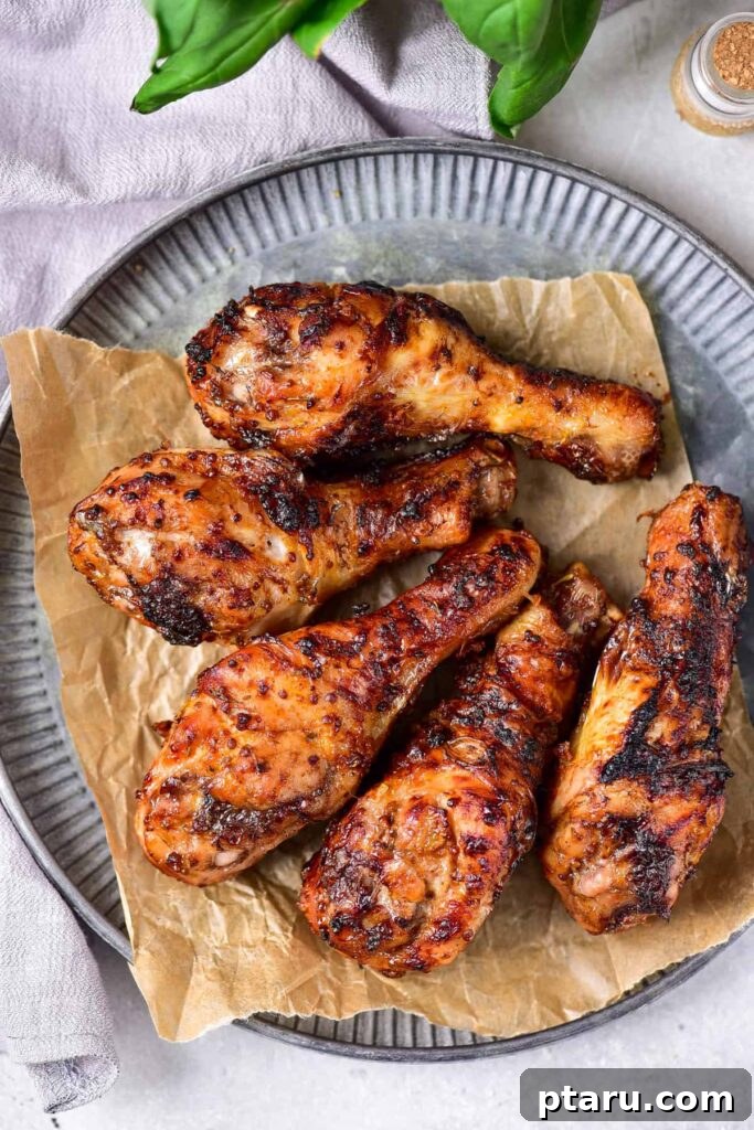 41 Succulent Chicken Drumstick Recipes You Can Make Effortlessly 25 Maple Mustard Chicken Legs served elegantly on a grey plate.