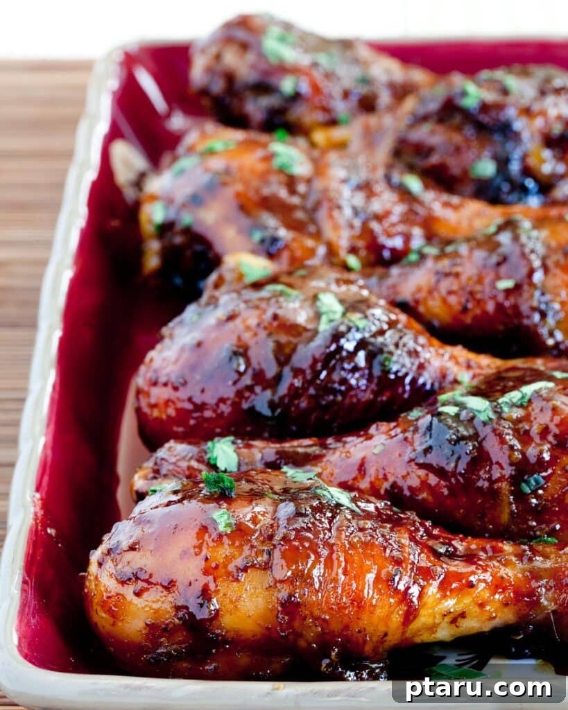 41 Succulent Chicken Drumstick Recipes You Can Make Effortlessly 26 Delicious Saucy Baked Chicken Drumsticks, glistening with sauce.