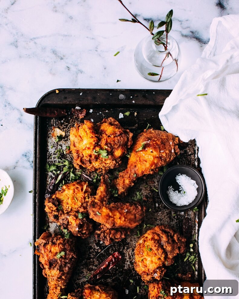 41 Succulent Chicken Drumstick Recipes You Can Make Effortlessly 7 Golden-brown Fried Tandoori chicken drumsticks arranged on a sheet pan.