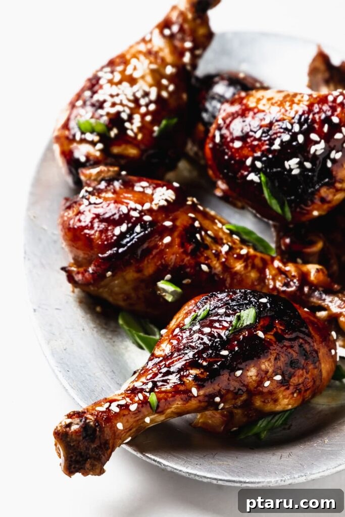 41 Succulent Chicken Drumstick Recipes You Can Make Effortlessly 9 Succulent Sesame Soy Chicken Drumsticks stacked on a small plate, ready to be enjoyed.