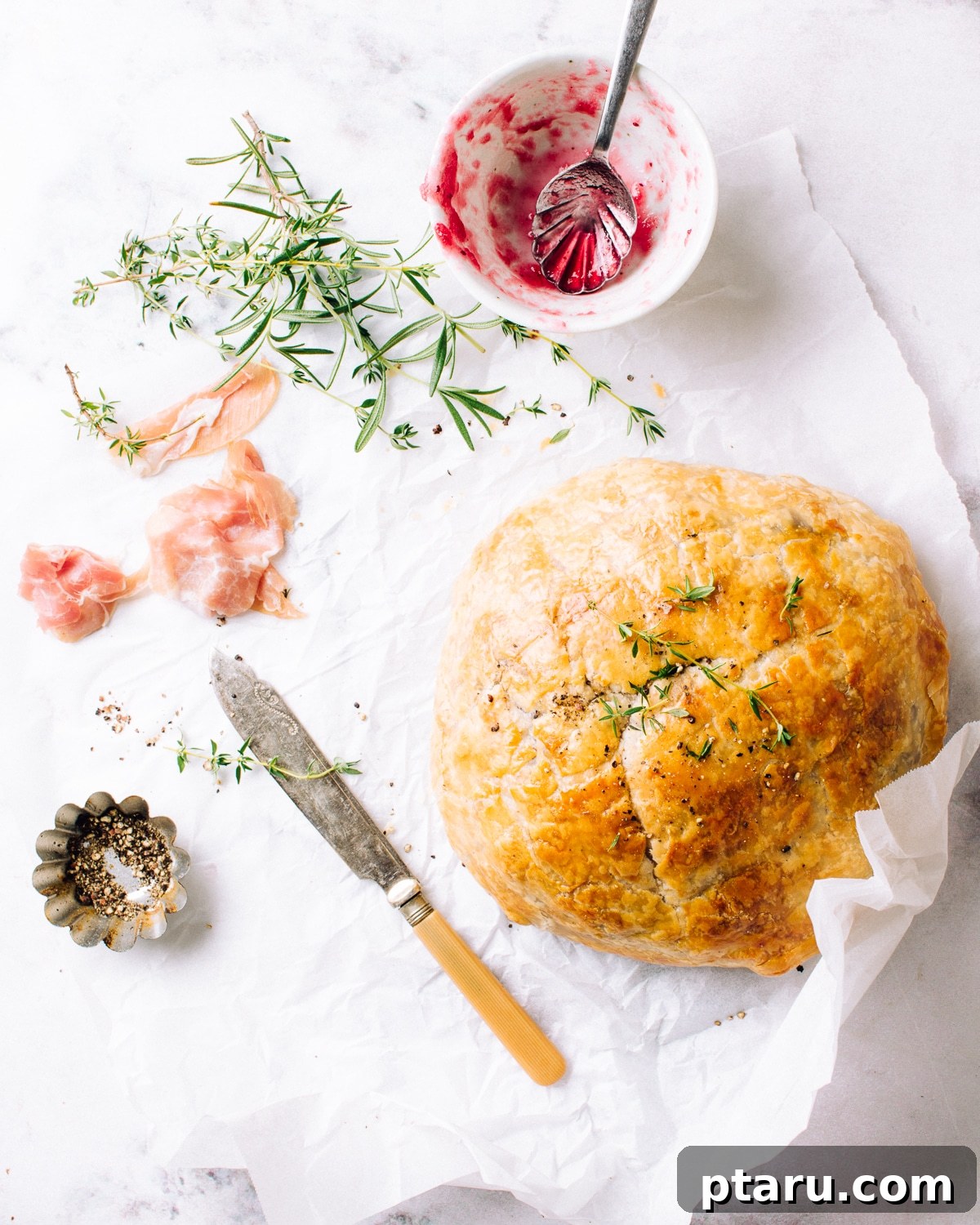 Golden Puff Pastry Brie with Prosciutto and Cranberry 9 Baked brie resting after coming out of the oven.