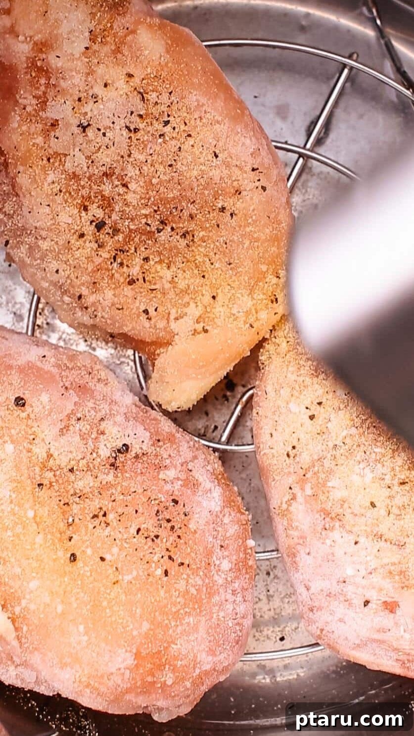 Zesty Slow Cooker Lemon Chicken 4 Seasoning chicken breasts with pepper.
