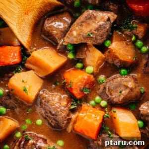 Pressure Cooker Beef Stew in Instant Pot with a wooden spoon.