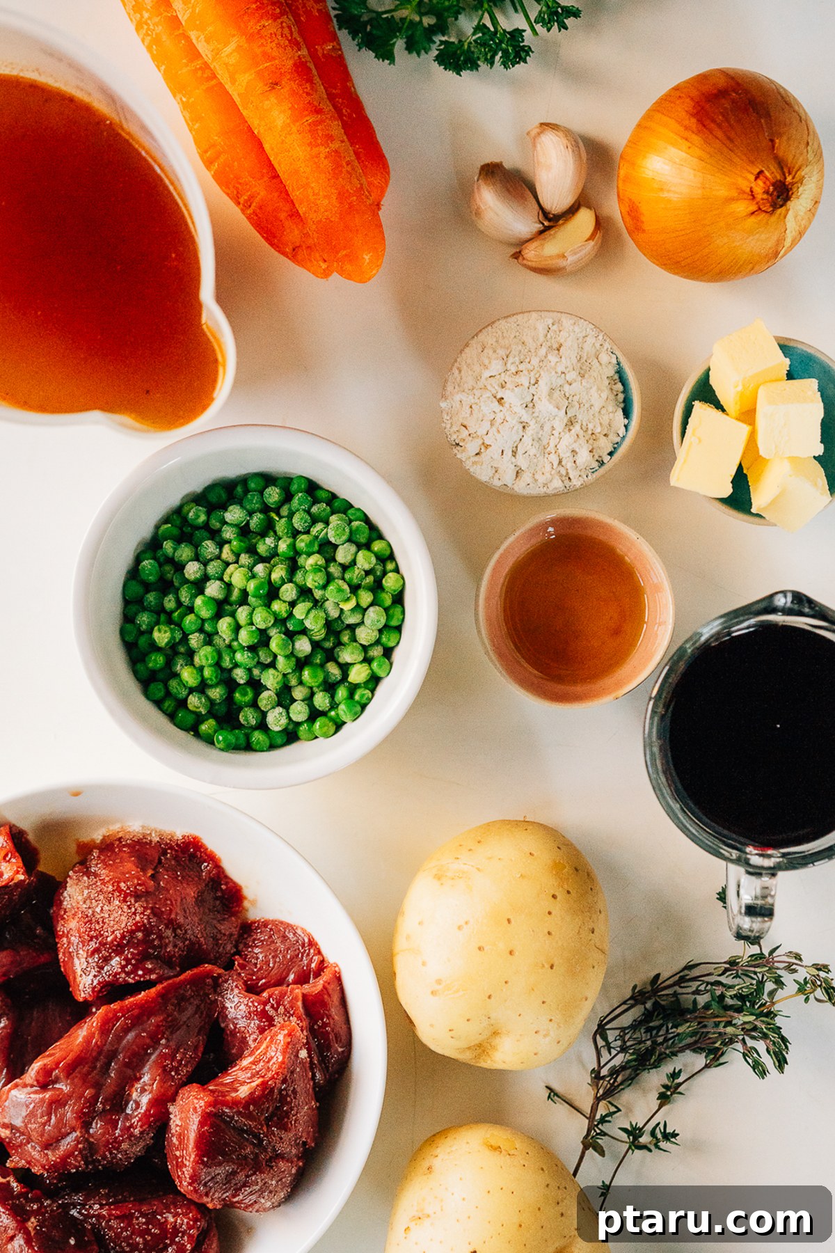Quick Comfort Beef Stew 3 Fresh ingredients for Pressure Cooker Beef Stew neatly arranged on a kitchen countertop, showcasing cubed beef, a variety of colorful vegetables, aromatic herbs, and liquid bases.
