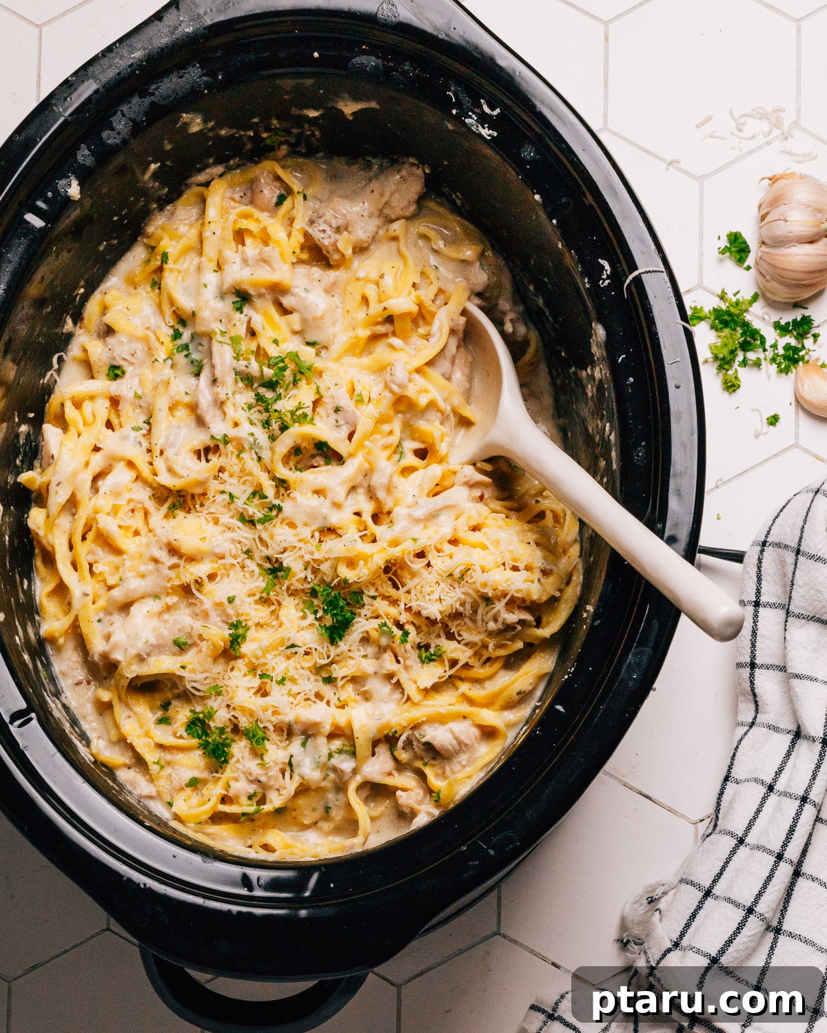 Creamy Slow Cooker Chicken Alfredo 2 Creamy Crockpot Chicken Alfredo Recipe in slow cooker with a spoon, ready to serve.