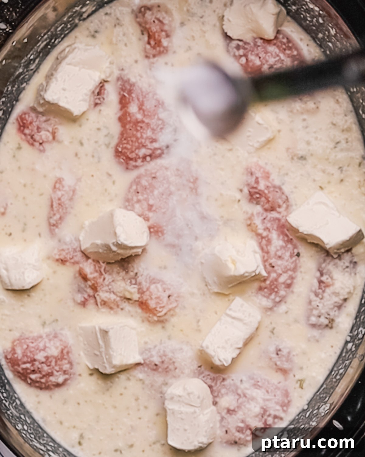 Creamy Slow Cooker Chicken Alfredo 5 Step 2: Adding seasoned chicken to the slow cooker.