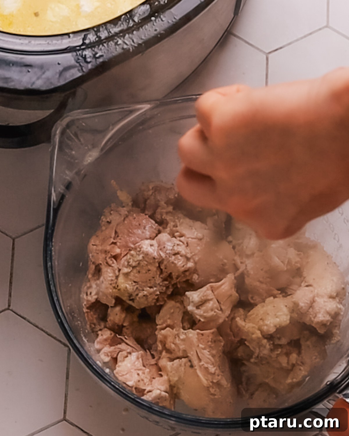 Creamy Slow Cooker Chicken Alfredo 6 Step 3: Adding sauce ingredients to the slow cooker with chicken.