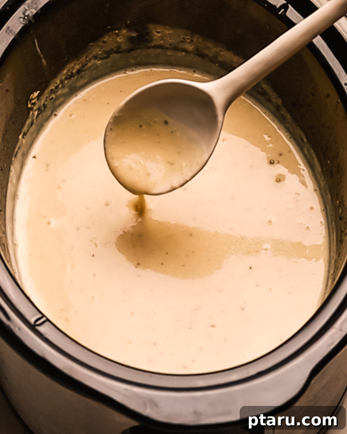 Creamy Slow Cooker Chicken Alfredo 7 Step 4: Creamy Alfredo sauce simmering in the slow cooker.
