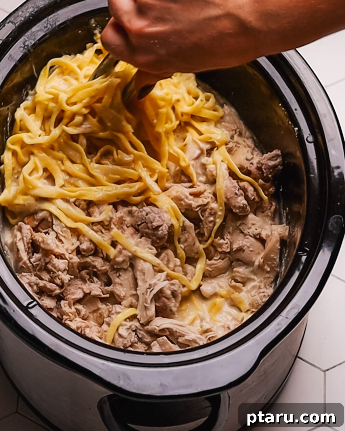 Creamy Slow Cooker Chicken Alfredo 8 Step 5: Shredding cooked chicken for Crockpot Chicken Alfredo.