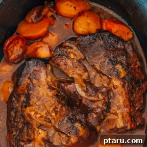 Chuck Roast in Crockpot with carrots and potatoes.