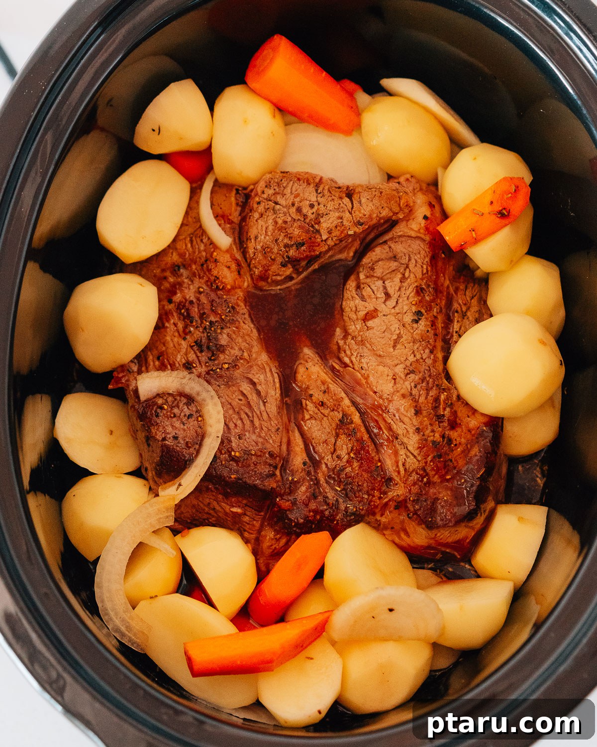 Slow Cooker Chuck Roast Melts in Your Mouth 6 Step 3: Adding all ingredients including beef, vegetables, and liquids to the slow cooker.