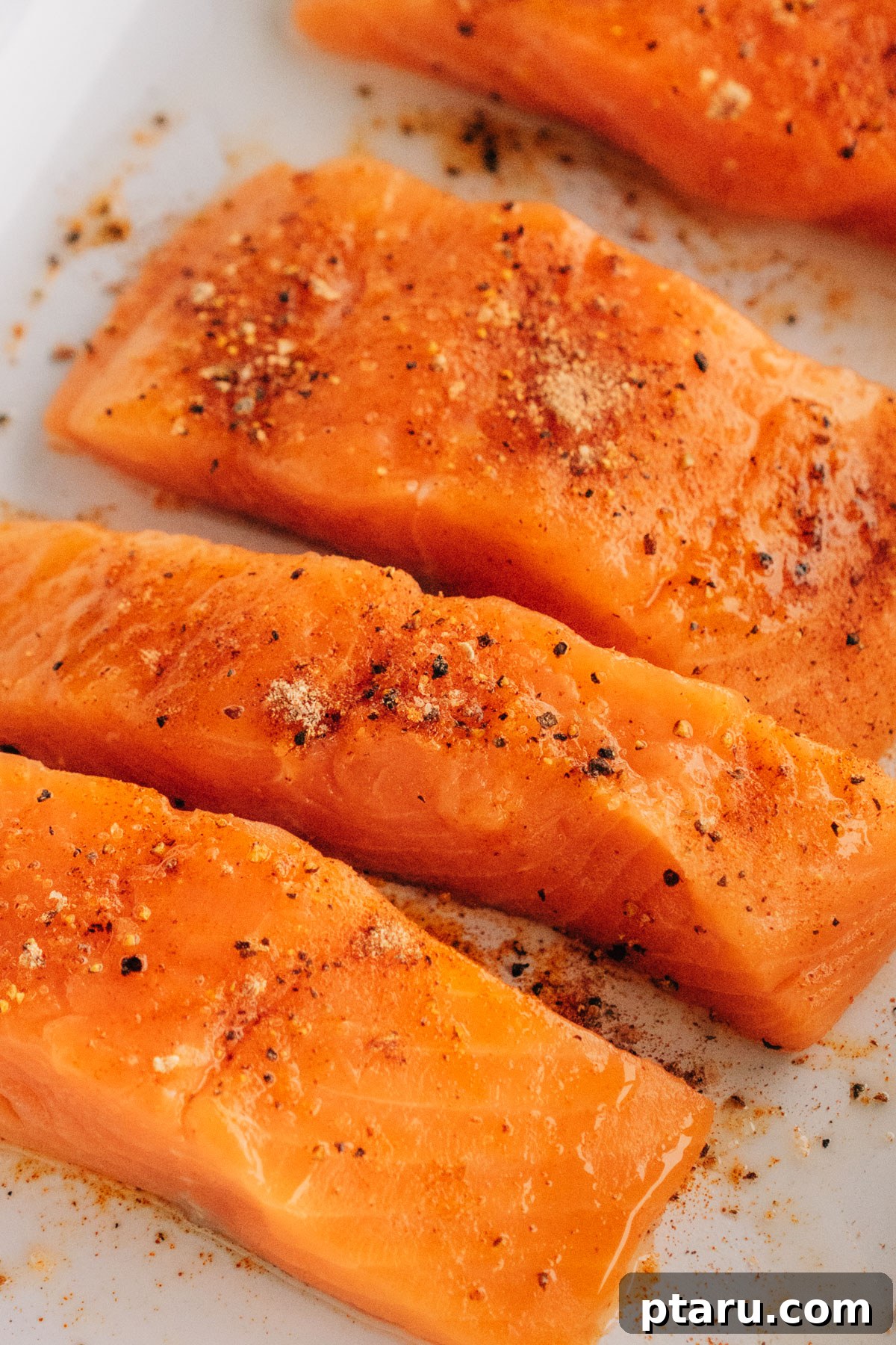 Succulent Grilled Salmon 5 Raw salmon seasoned on a plate.