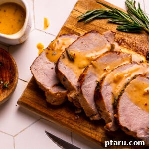 Pork gravy drizzled over roast pork loin.