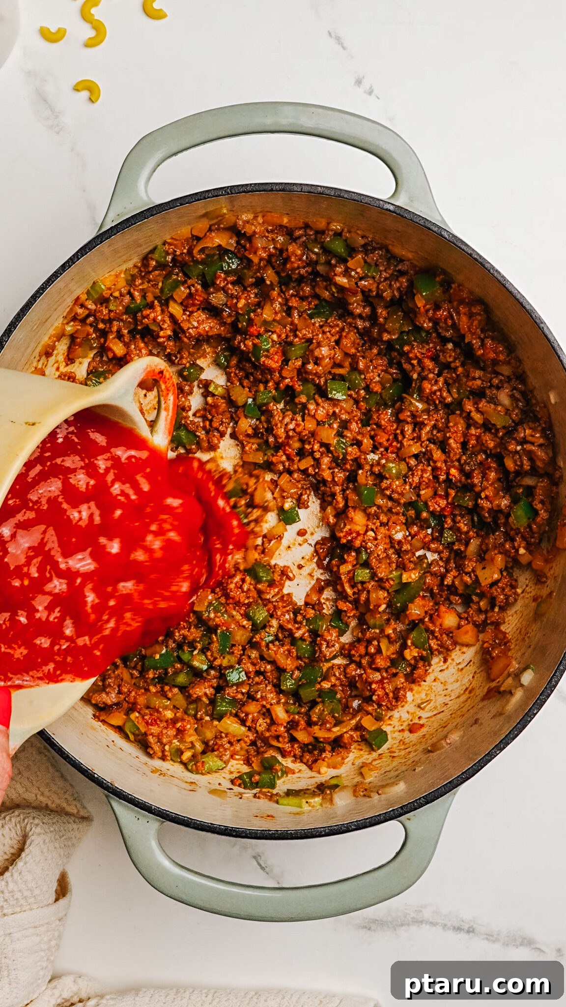 Classic Macaroni Goulash 6 Step 3: Sautéing diced onions, bell pepper, and celery in the same Dutch oven with the browned beef pushed aside.