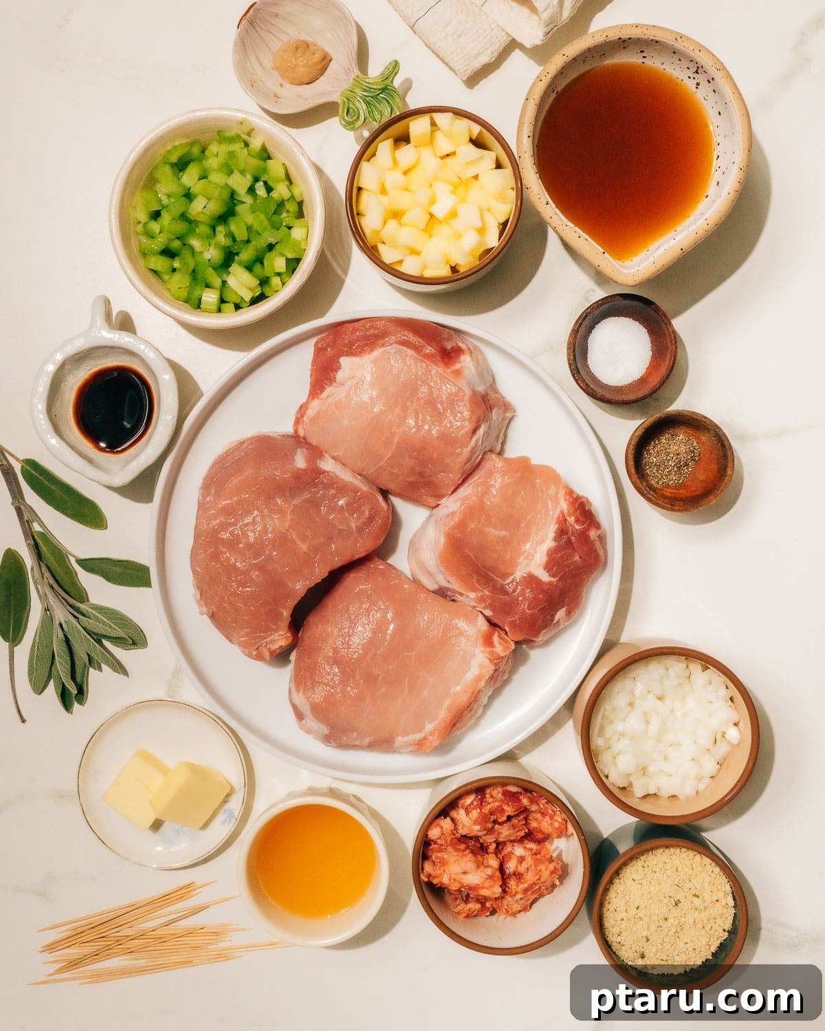 Juicy Stuffed Pork Chops with Luscious Pan Sauce 3 A carefully arranged collection of fresh ingredients for stuffed pork chops, including thick-cut pork chops, apples, onions, celery, Italian sausage, herbs, and spices, laid out on a clean kitchen surface.