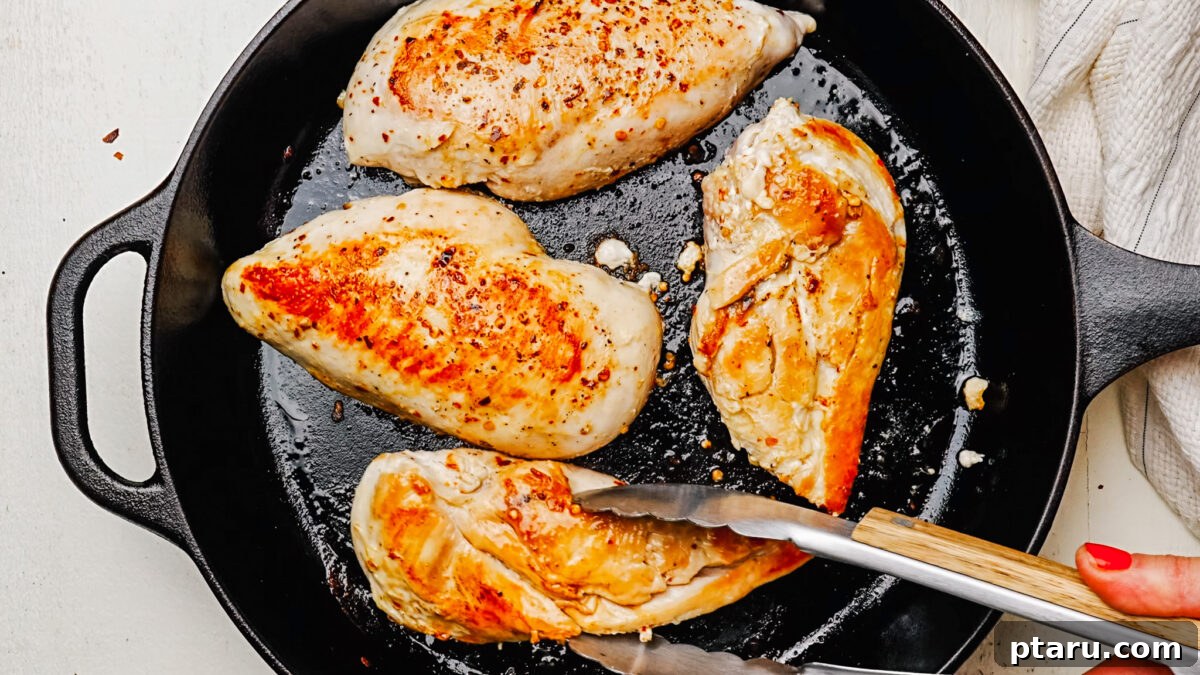 Creamy Chicken Alfredo Perfection 4 Searing chicken breast in a large skillet until golden brown.
