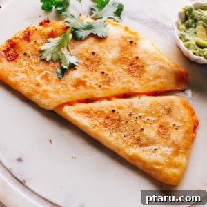 Golden and crispy Chicken quesadilla topped with cilantro.