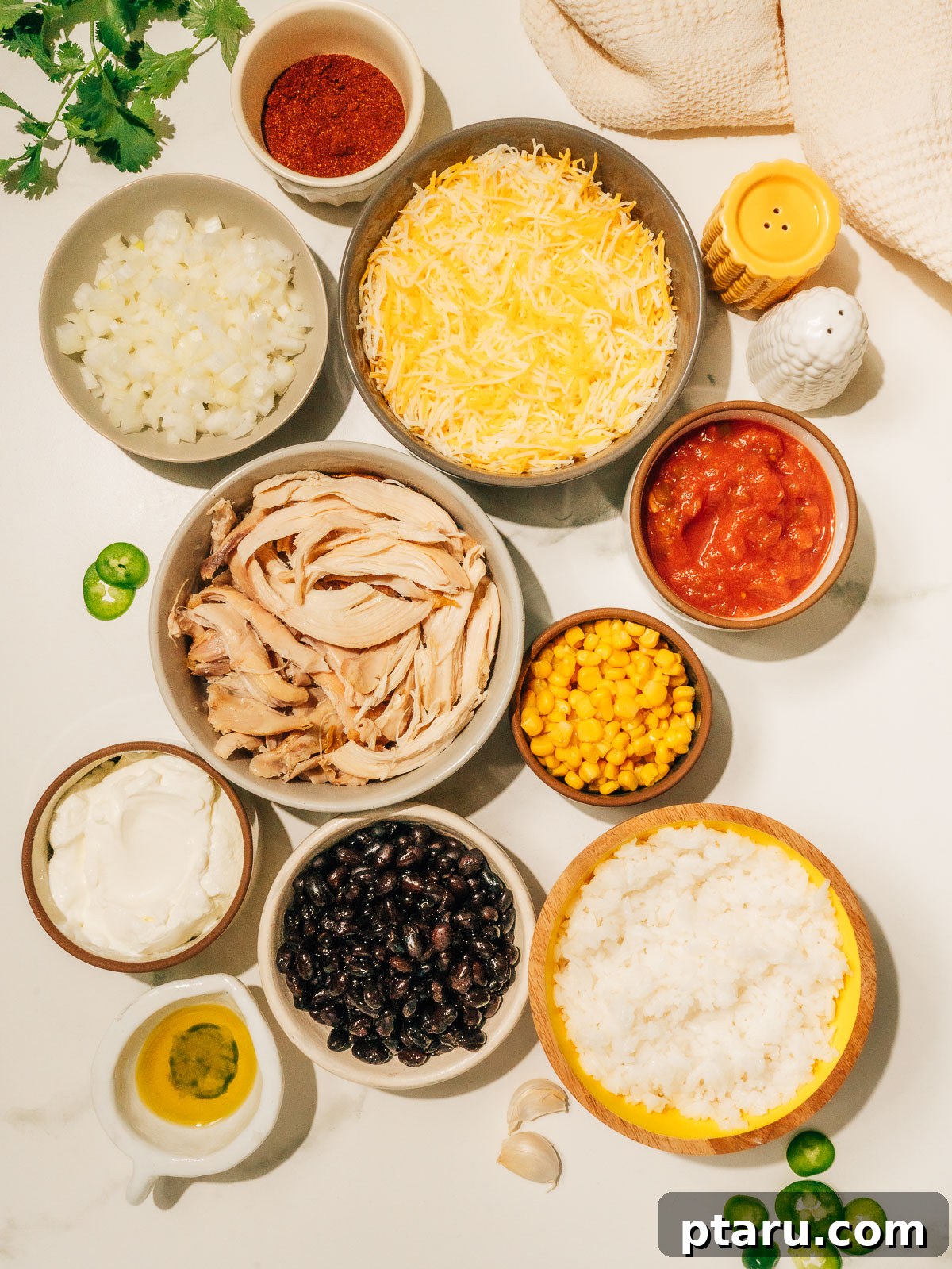 Fiesta Chicken Bake 3 Fresh ingredients laid out for making Mexican Chicken Casserole, including chicken, rice, beans, and corn.