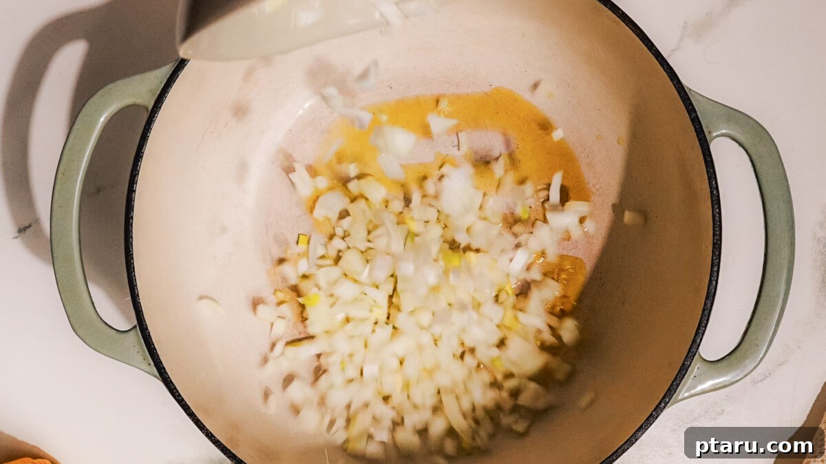 Fiesta Chicken Bake 4 Step 1: Sautéing onions and garlic in a skillet for Mexican Chicken Casserole.