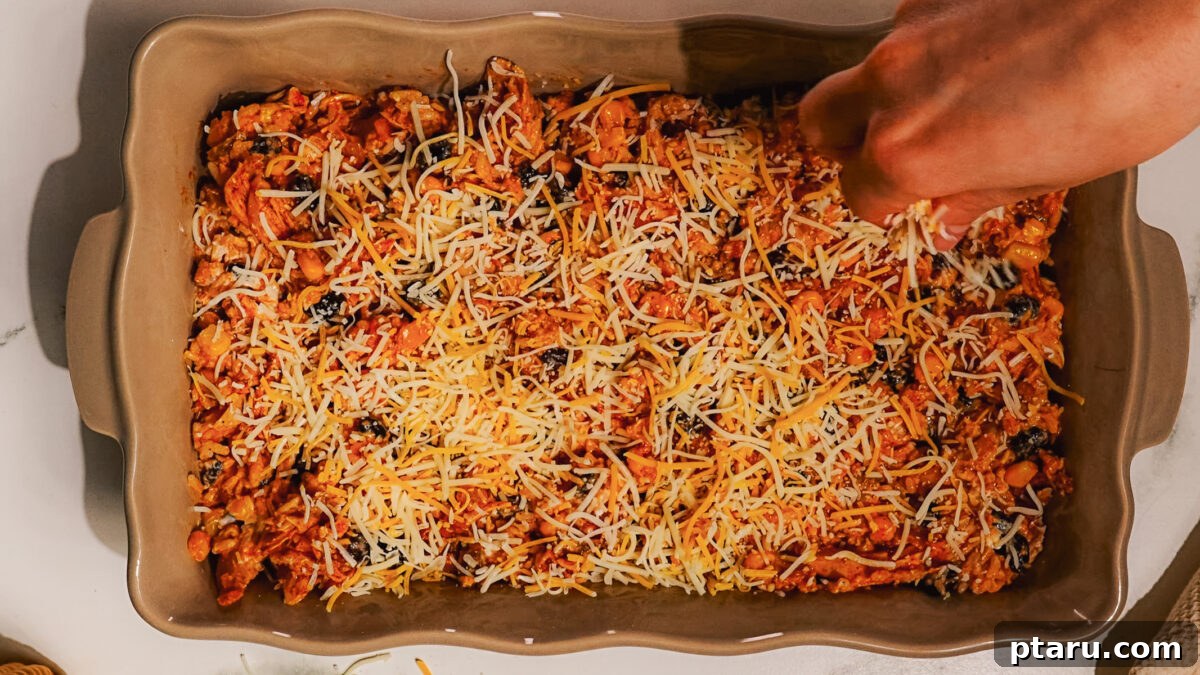 Fiesta Chicken Bake 7 Step 4: Spreading the Mexican Chicken Casserole filling evenly into a baking dish.