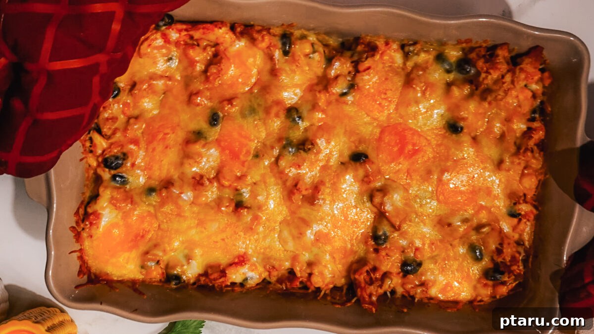 Fiesta Chicken Bake 8 Step 5: Topping the casserole with a generous layer of shredded cheese before baking.