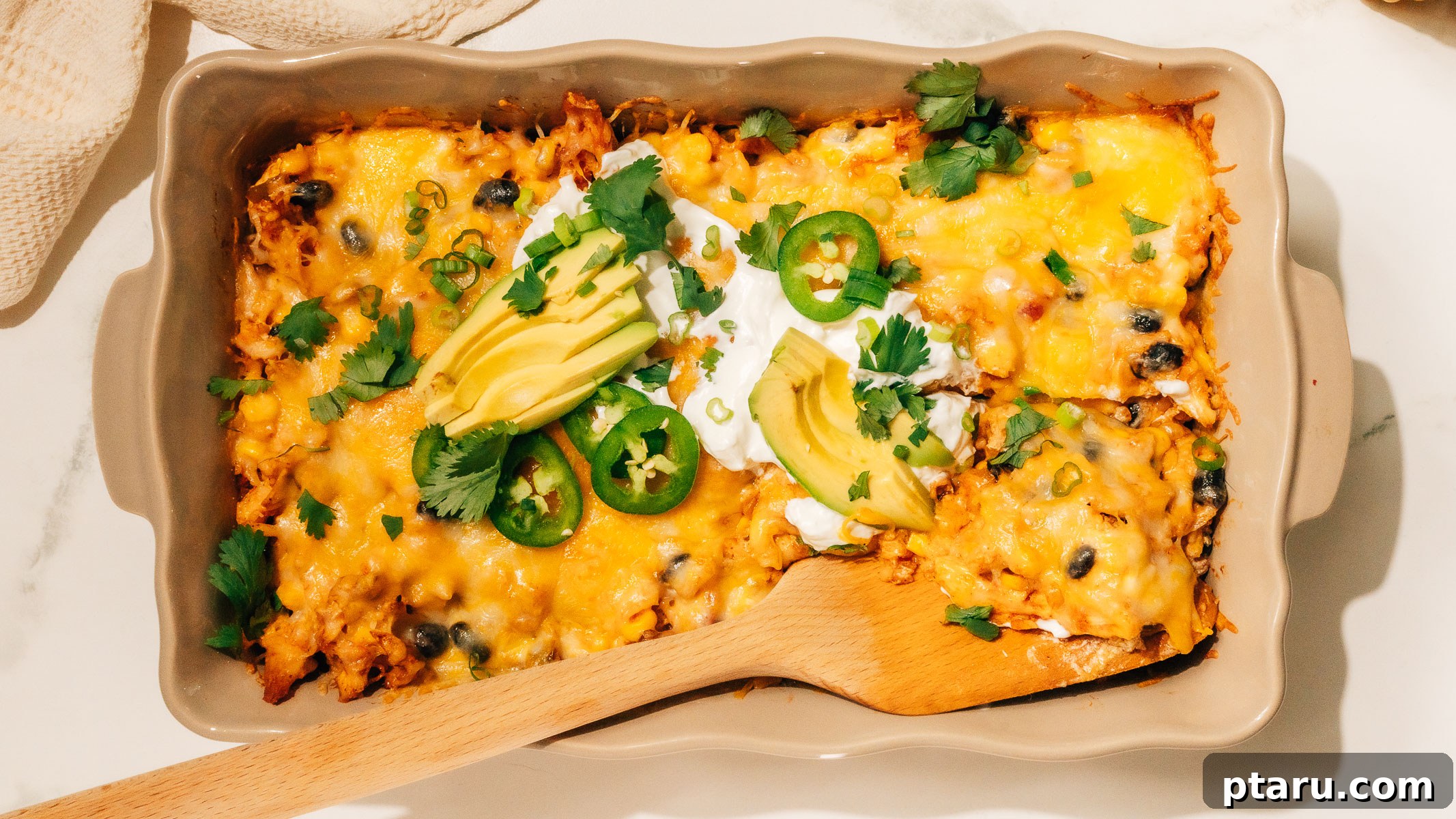 Fiesta Chicken Bake 9 A serving of Mexican Chicken Casserole on a plate with fresh toppings like avocado and cilantro, ready to eat.