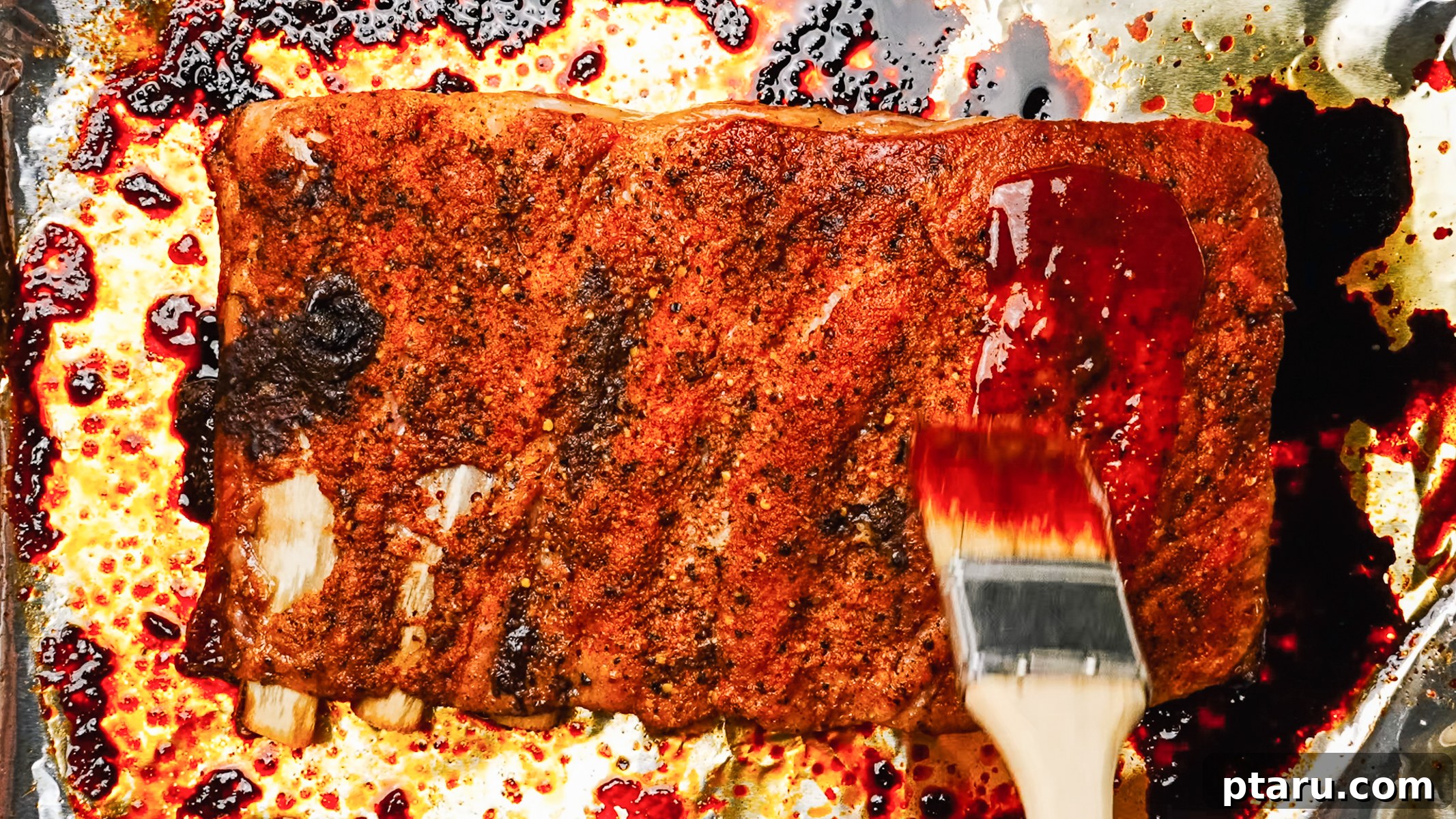 Butter-Soft Spare Ribs 8 Step-by-step photos showing how to bake spare ribs in the oven: 5. Applying BBQ sauce before broiling.