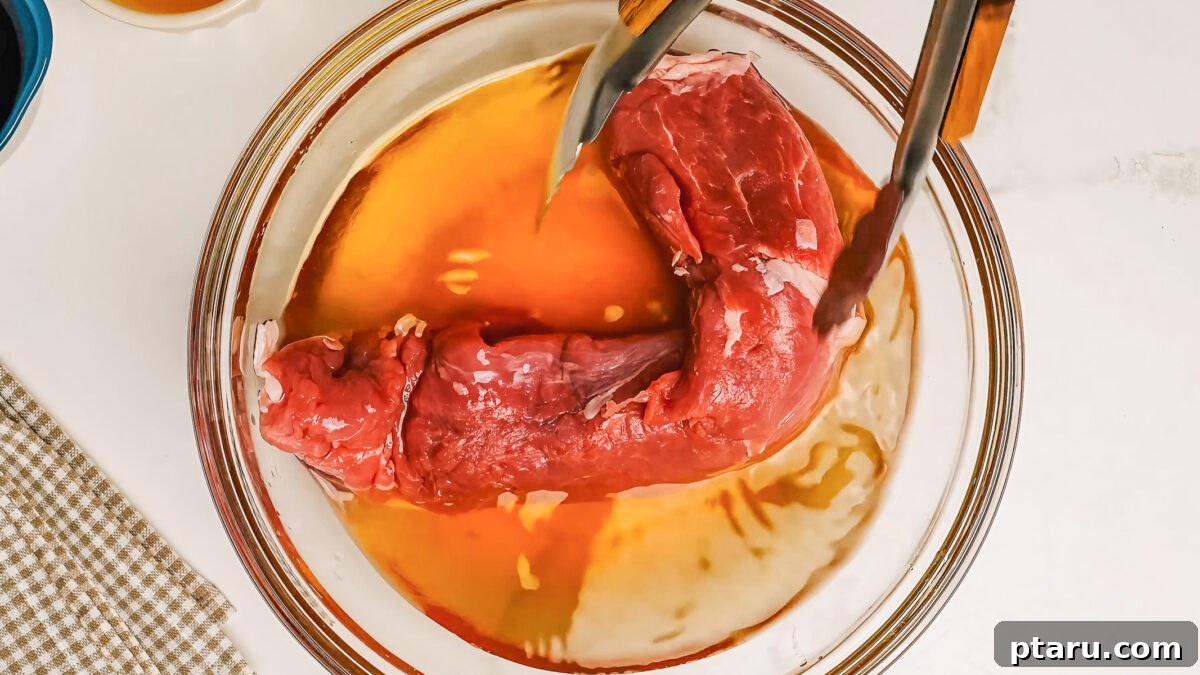 Melt-in-Your-Mouth Pork Tenderloin Recipe 5 Brining pork tenderlion in a bowl.