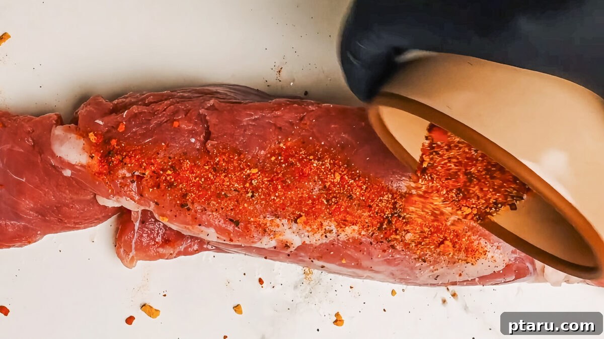 Melt-in-Your-Mouth Pork Tenderloin Recipe 7 Adding spice rub to pork tenderloin.
