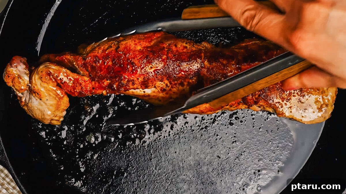Melt-in-Your-Mouth Pork Tenderloin Marinade 6 A succulent pork tenderloin searing to a beautiful golden-brown crust in a hot cast iron skillet, a crucial step for flavor development.