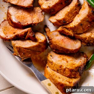 Perfectly sliced marinated pork tenderloin recipe on a plate, showcasing a delicious meal.