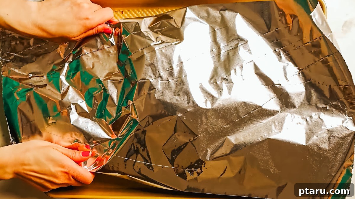 Slow Roasted Tender Beef Ribs 7 Step 3: Beef back ribs wrapped in foil with apple cider vinegar, ready for baking.
