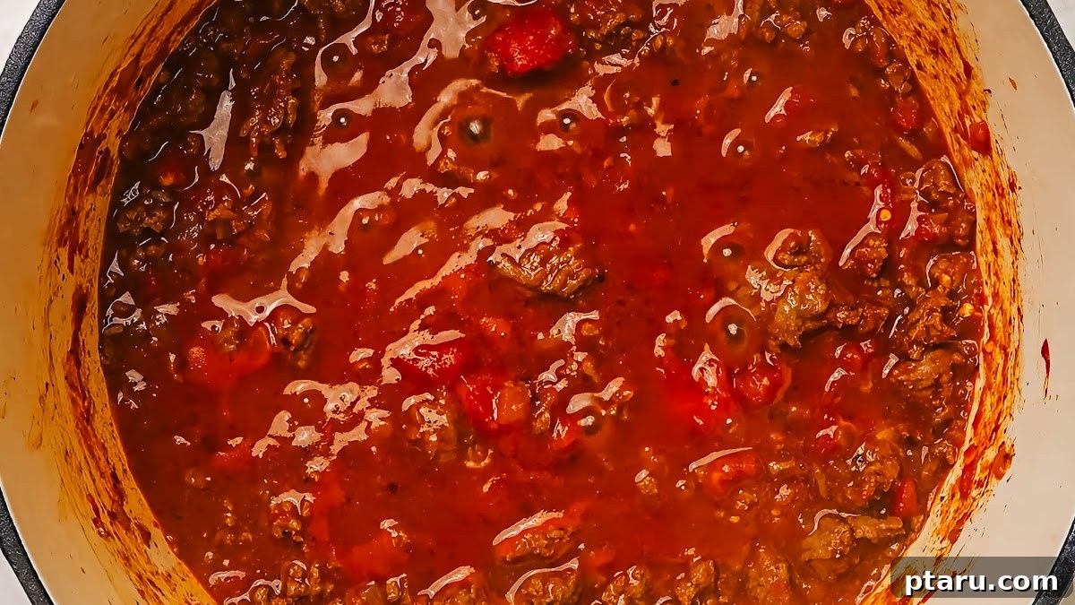 Hearty Beef Spaghetti Made Simple 6 Simmering ground beef spaghetti sauce in a skillet