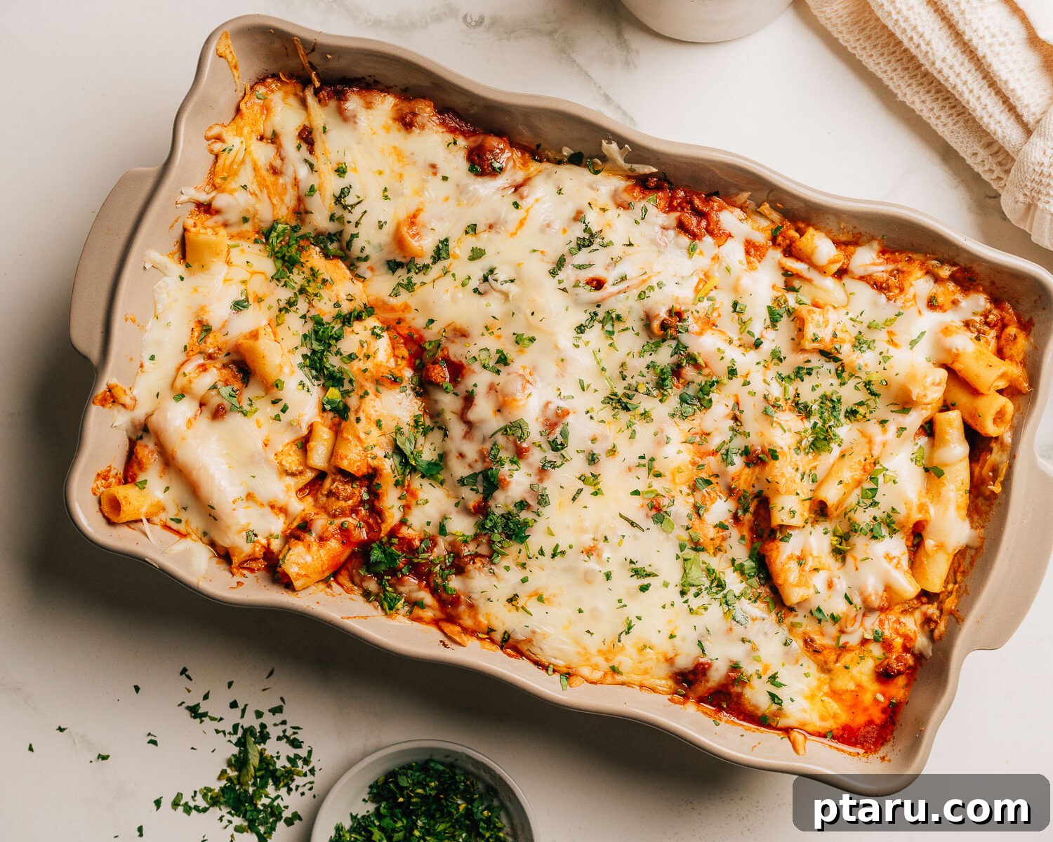 Ultimate Ricotta Ziti Bake 10 Baked ziti with ricotta topped with minced parsley and ready to be served.