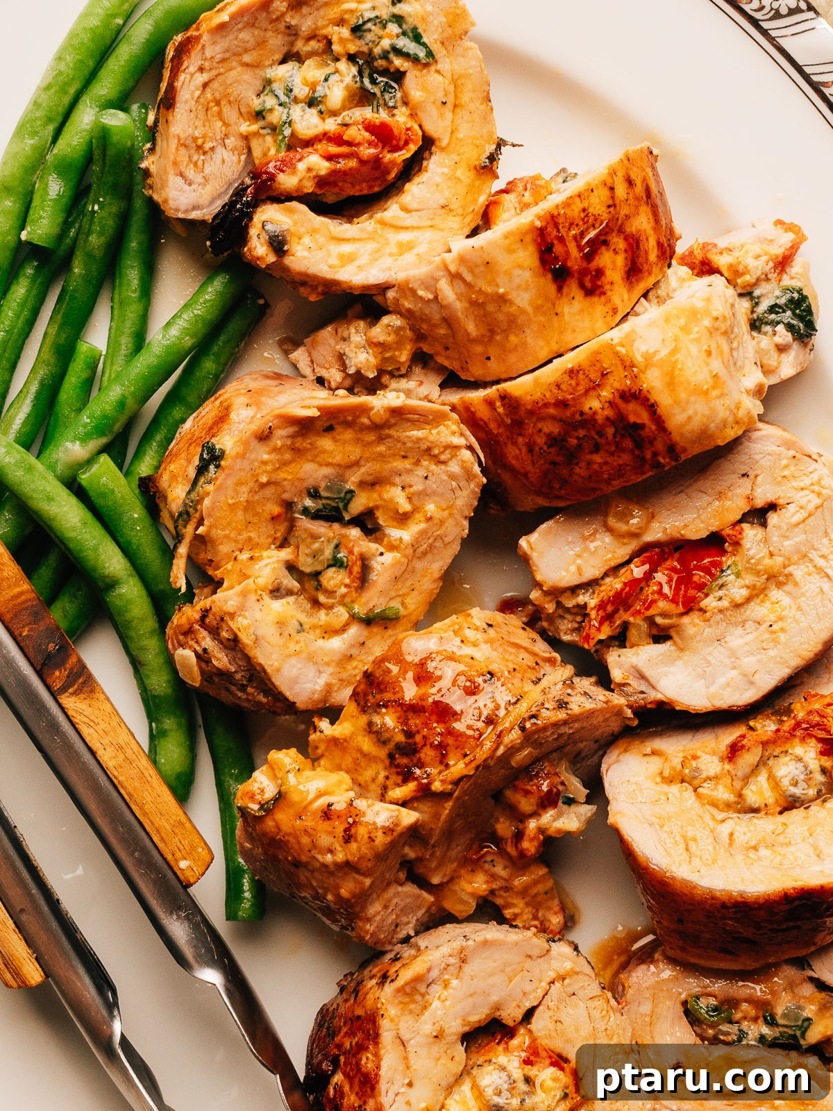 Creamy Mediterranean-Stuffed Pork Tenderloin: Tender Roast Recipe 2 Close up of stuffed pork tenderloin rounds with creamy Mediterranean filling.
