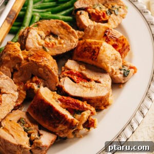 Creamy Mediterranean-Stuffed Pork Tenderloin: Tender Roast Recipe 13 Sliced stuffed pork tenderloin showing creamy sun-dried tomato and spinach filling.