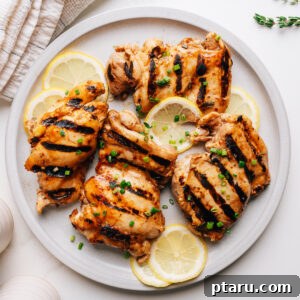 Juicy Grilled Boneless Chicken Thighs with Marinade 11 Grilled chicken thighs with balsamic chicken marinade on a plate.