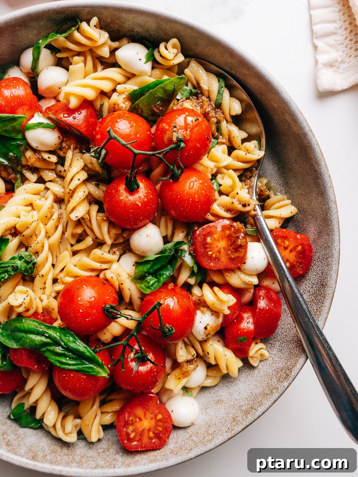 4th of July Recipes: Crowd-Pleasing Patriotic Dishes 23 Caprese pasta salad with cherry tomatoes, mozzarella, and basil.