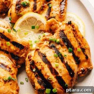Grilled chicken thighs with balsamic chicken marinade on a plate.