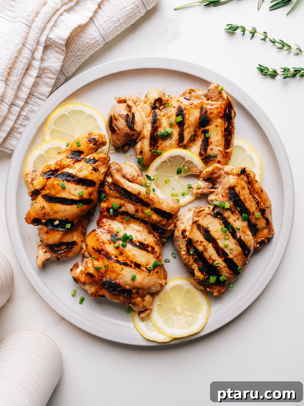 Grilled chicken thighs with balsamic chicken marinade on a plate.