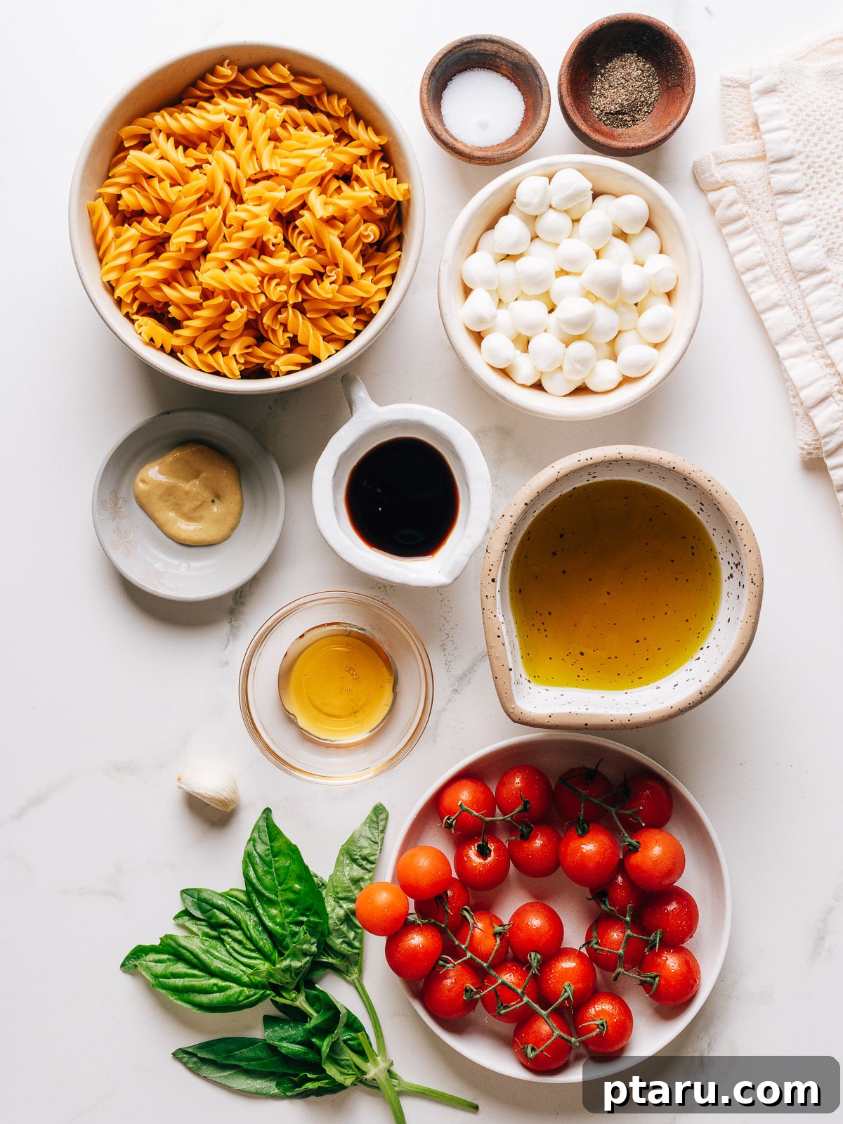 Caprese Pasta Salad with Cherry Tomatoes, Basil & Mozzarella 3 Caprese pasta salad ingredients on a countertop.