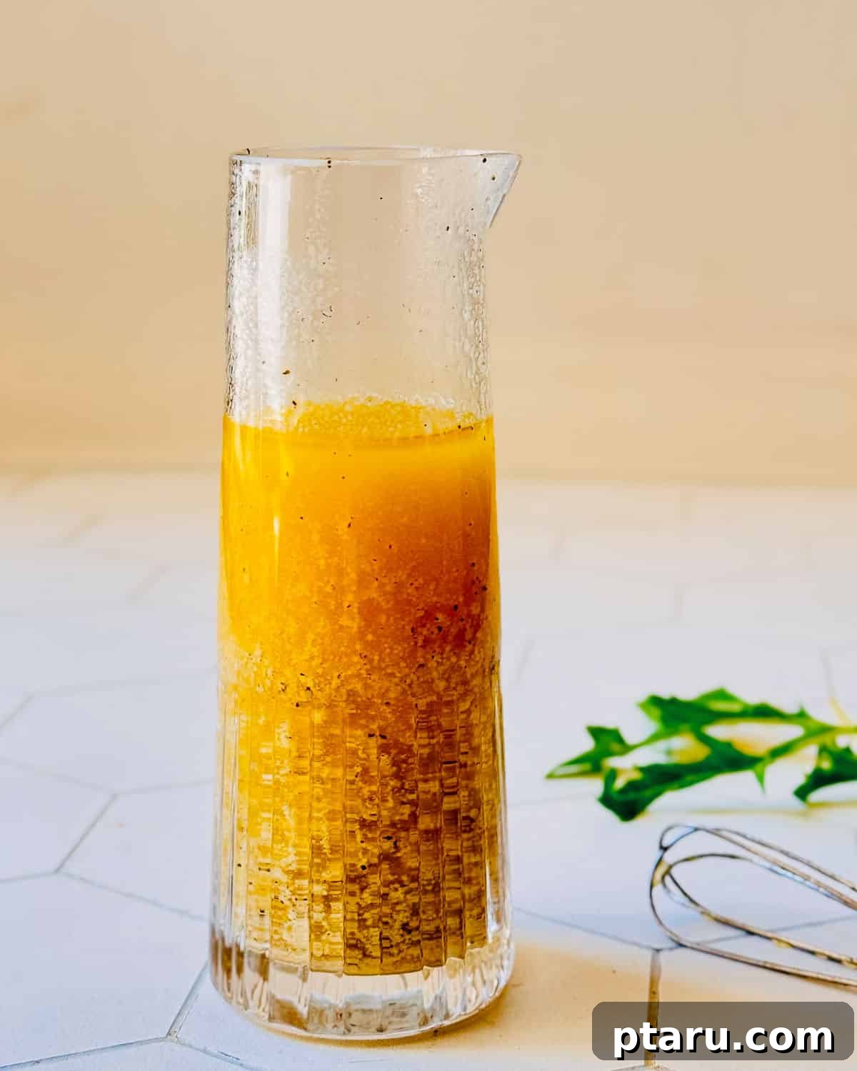 Tangy Dijon Vinaigrette Recipe for Zesty Salads 5 Dijon vinaigrette in a jar with a whisk beside it
