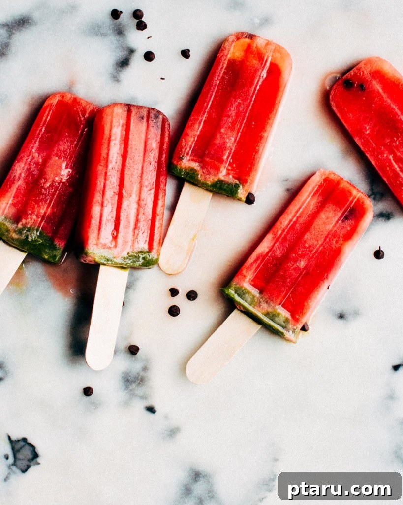 18+ Homemade Frozen Treats: Popsicle and Ice Cream Recipes 3 Watermelon popsicles on a stick.