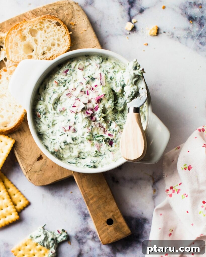4th of July Appetizer Ideas for Patriotic Gatherings 3 Creamy sour cream spinach dip in a serving bowl.
