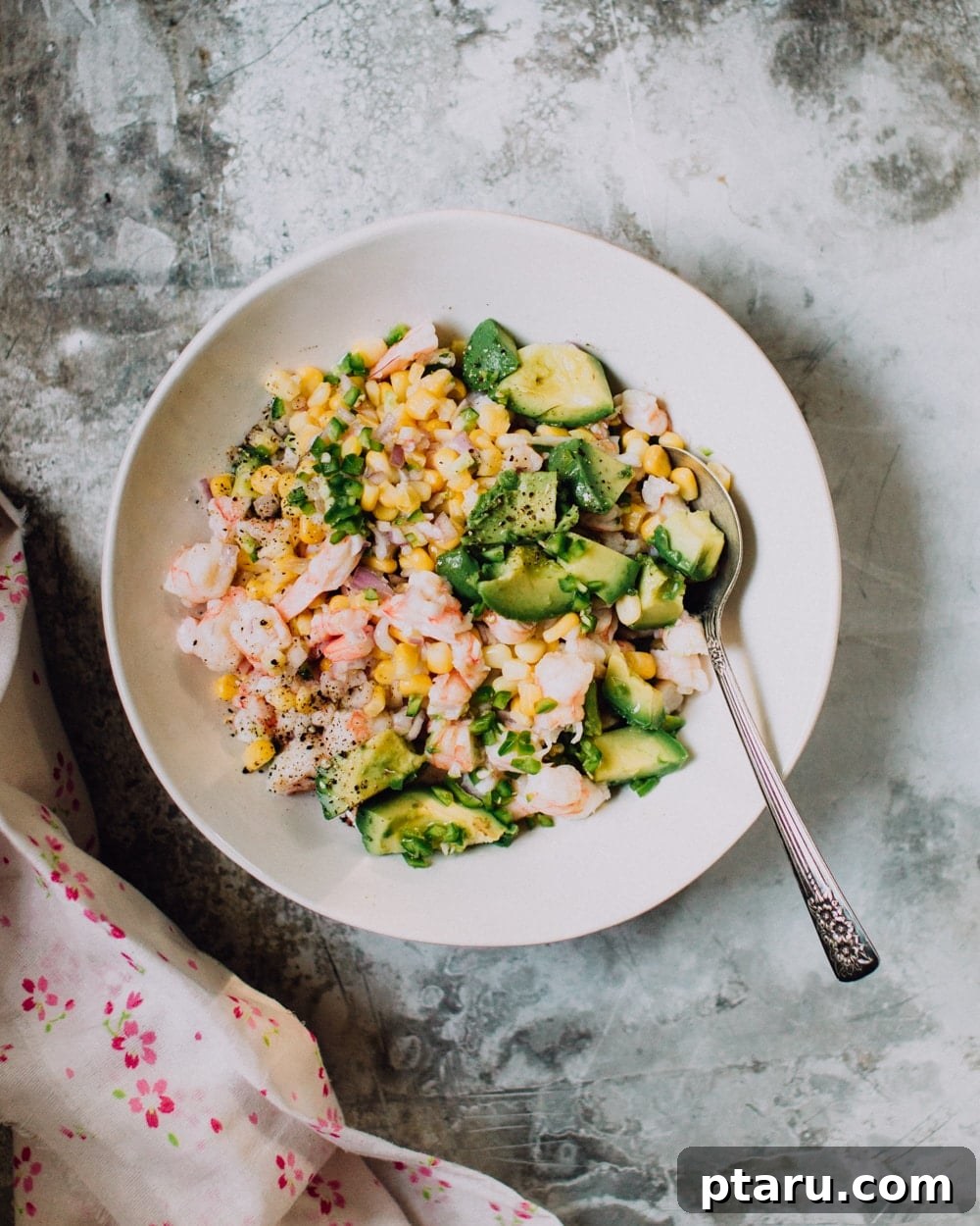 Shrimp, corn, and avocado ceviche in a bowl.